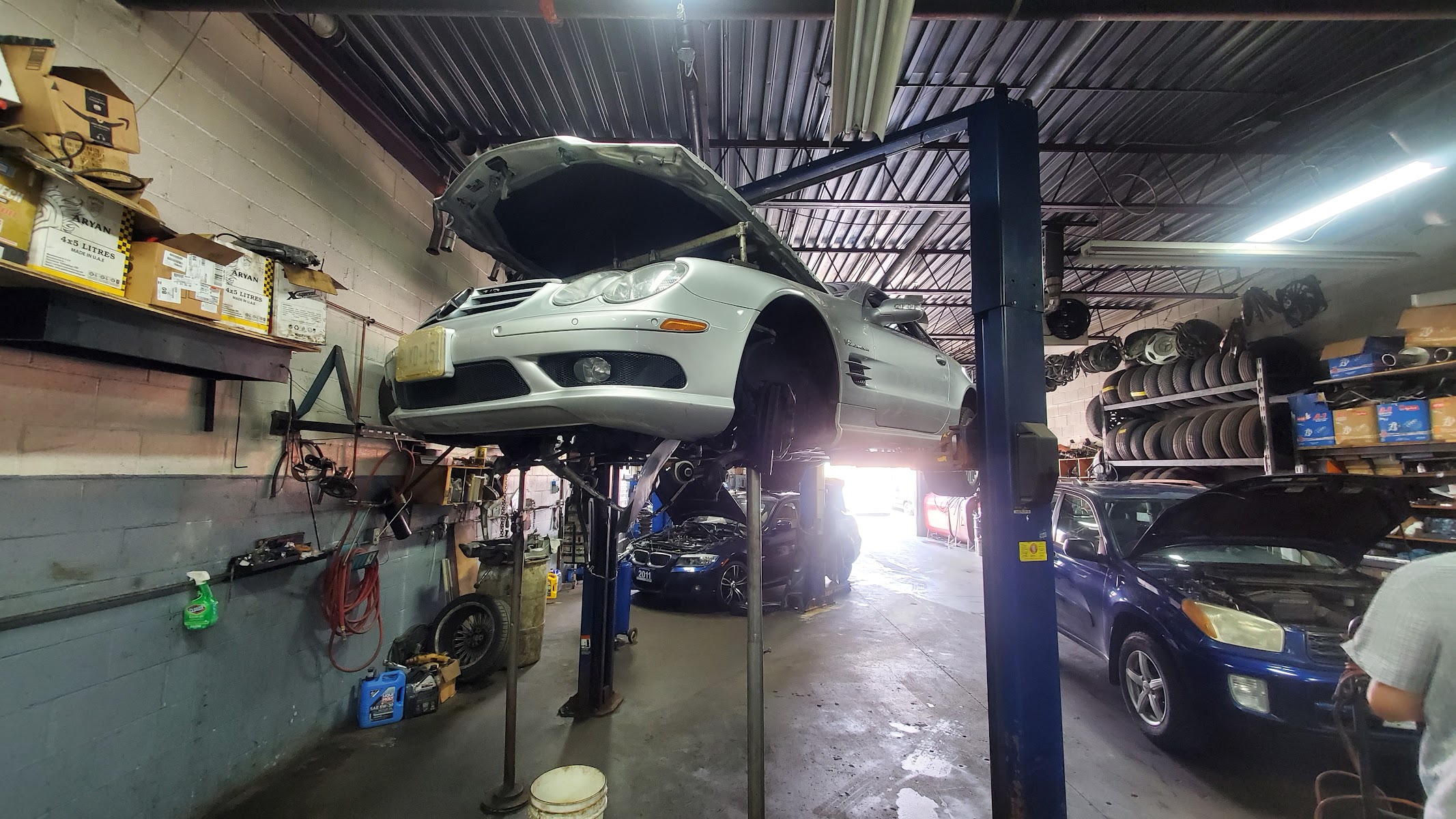 A car raised on the lift at Shahin Motors, mid-service